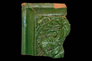Fragment einer Blattkachel mit Ritter beim Gesteck in rundem Medaillon mit losem Tauband, grün glasiert, Oberrhein, um 1450, Partenstein, Burg Bartenstein, H. 10,8 cm, Br. 9,5 cm 
