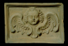 Fragment des Models einer Blattkachel mit geflügeltem Puttenkopf, unglasiert, Anfang 18. Jh., H. 18,5 cm; Br. 26,5 cm, Stuttgart, Württembergisches Landesmuseum